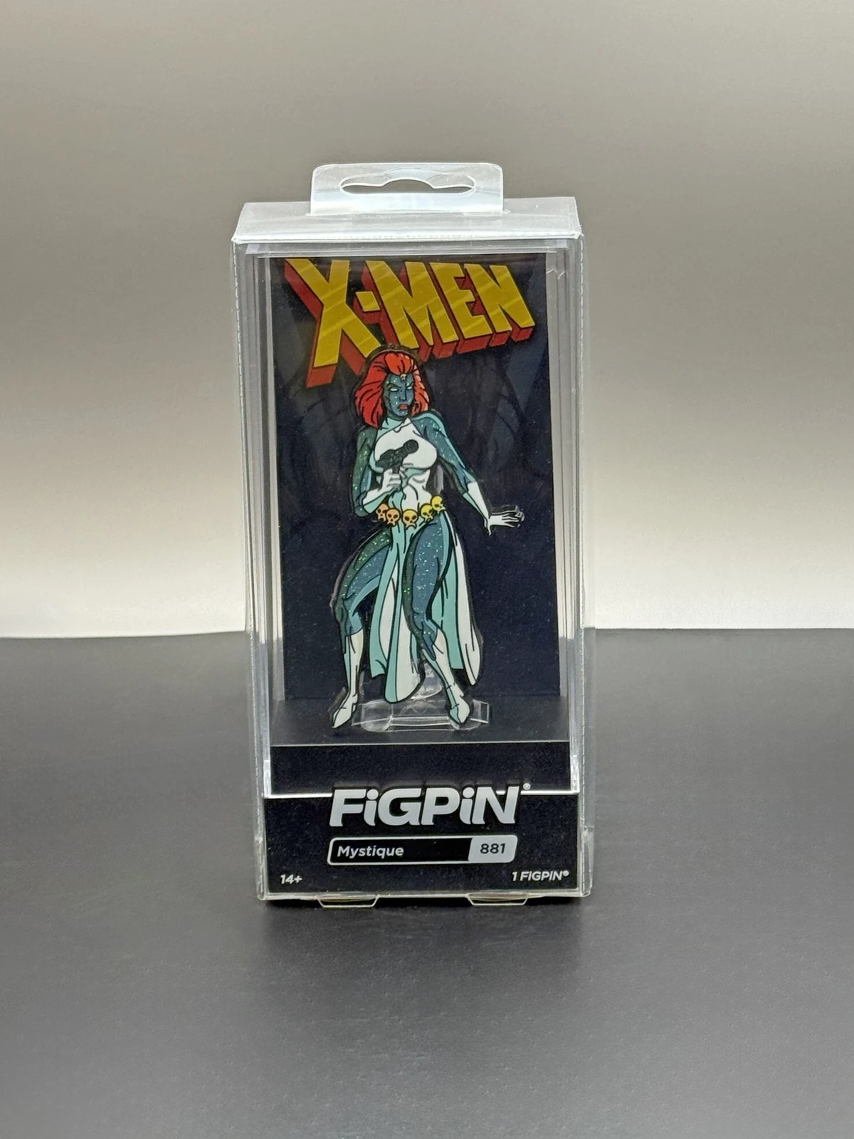 Front of Mystique FiGPiN #881 in its display case